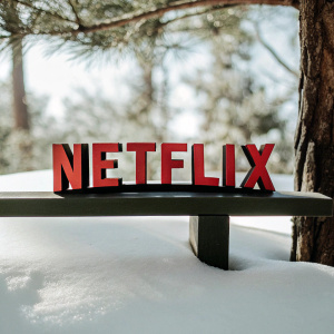Netflix logo featuring 'NETFLIX' in vivid red on a sleek black backdrop. Minimalist design.