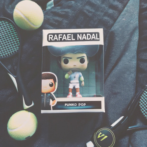 Rafael Nadal's Funko Pop figure. The box is vibrant with tennis motifs. It has English and Spanish language details