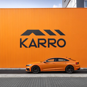 Karró logo, sleek, contemporary design. Black font on vibrant orange background. Modern graphic design.