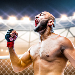 Siyar Bahadurzada, the UFC fighter, striking a powerful pose. Bald head and beard visible. UFC event atmosphere with dark arena background and bright spotlights highlighting him. He's wearing UFC gear, no shirt. Intense focus in his eyes.