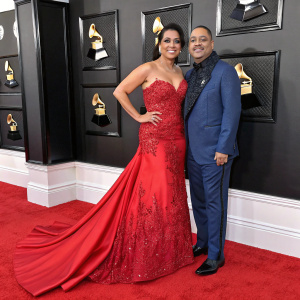 Lisa Lisa and Alex Spanador Moseley attend the Grammy Awards. They are both wearing elegant gowns and posing for a photo.