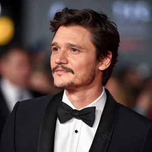 Pedro Pascal at the Star Wars Celebration event. Formal black tuxedo, crisp white shirt, black bow tie. Close-up portrait, blurred background.