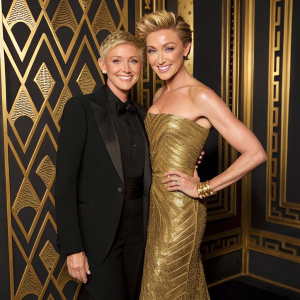 Ellen DeGeneres and Portia de Rossi posing for a glamorous magazine cover shoot. The background features a luxurious gold and black pattern.