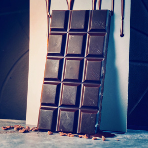 Cadbury Galaxy chocolate bar packaging design. Sleek, dark brown color with modern drip effect. Elegant and eye-catching, highlighting smooth milk chocolate texture.