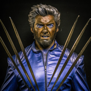 Hugh Jackman as Wolverine. Silver hair, rugged face. The background is a stark black.