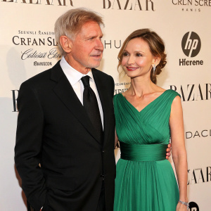 Harrison Ford and Calista Flockhart attend a glamorous charity gala. The backdrop features an array of luxury brands. Harrison dons a classic black suit, while Calista opts for an elegant emerald green dress.