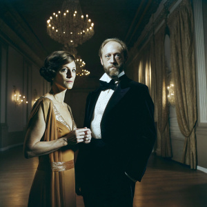 Sarah Clarke and Xander Berkeley attending a gala. Lavish ballroom setting with chandeliers. Donating to Life Through Art Foundation.