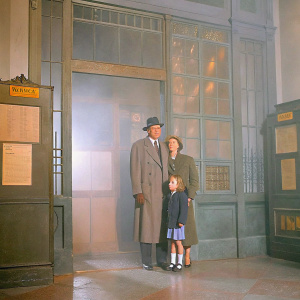 A vintage scene from 'Spellbound'. Gregory Peck, Ingrid Bergman, and a little girl are in a post office. The atmosphere is tense and filled with anticipation.