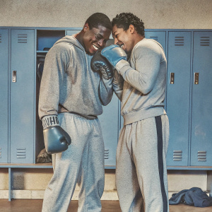Adrien Broner and Jesse Vargas in a candid moment. They are in the locker room after a fight. Both are wearing sweatpants and boxing gloves.