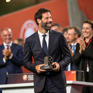 Ruud van Nistelrooy at a football gala. Wearing formal suit, receiving an award. Applause in the background.