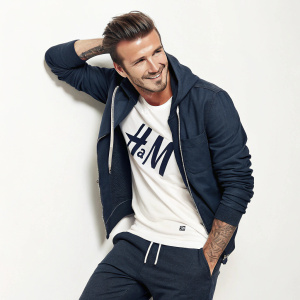 David Beckham in a casual outfit, featuring the H&M logo. He poses with a smile against a white background.