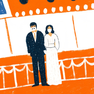 Simon Cowell and Jackie St Clair at the Golden Globe Awards. Simon in a dark suit, Jackie in a white mask-covered gown. Standing behind a large illuminated sign featuring sponsor logos.