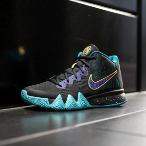 High-resolution image of a Nike Kyrie 4 Mamba Mentality sneaker. Predominantly black with accents of blue and teal. Displayed against a sleek black backdrop to highlight its cutting-edge design and intricate patterns.