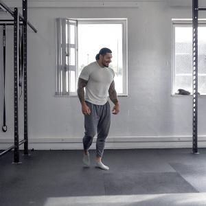 Sonny Bill Williams, NZ rugby star, in casual wear. Dark hair, beard. Gym setting, fitness equipment visible.