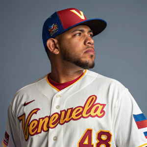 Jose Alvarez, baseball player, in professional uniform, Venezuelan team logo, number 48 on jersey. Gray background, headshot