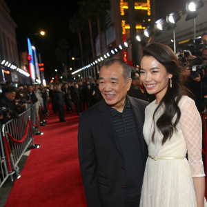 Shu Qi and Hou Hsiao-Hsien at a bustling Hollywood premiere. Crowds and flashing cameras surrounding them.