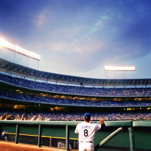 Mike Moustakas, wearing a white jersey with his number 8, at a baseball stadium. Crowd cheering in the background.