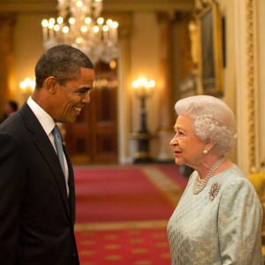 Barack Obama and Queen Elizabeth II in a candid moment at Buckingham Palace, medium shot.