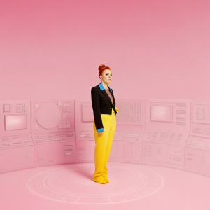 Scarlett Johansson as Natasha Romanoff. Stark Industries setting. Sci-fi backdrop, lab with holograms and tech. Determined expression, red hair in a bun, black suit with blue details