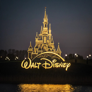 Golden Walt Disney castle logo on dark background, intricate design, flowing script text below