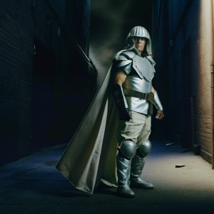 Shredder, from the Teenage Mutant Ninja Turtles series, standing in a dark alley. Background filled with ominous shadows and industrial brick walls.