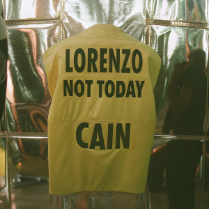 Lorenzo Cain's merchandise display. Bold 'Not Today' graphic printed on a yellow athletic shirt. Shiny, modern sports shop backdrop.