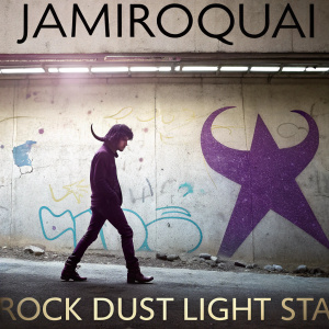 Album cover art for Jamiroquai's 'Rock Dust Light Star'. Stylized silhouette with horns in a purple hue. Set against a graffiti-covered concrete wall.