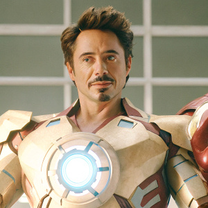 Digital artwork featuring Tony Stark, a.k.a Iron Man, from Marvel Universe. Wears sleek armor, heart-shaped arc reactor, minimalist gray backdrop
