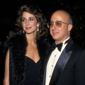Paul Shaffer and Cathy Vasapoli at the annual Grammy Awards. Cathy in a sleek black dress with fur-like accents, Paul in formal tuxedo. Dark backdrop