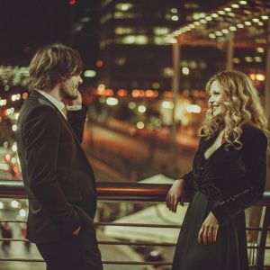 Close-up of Rupert Friend and Michelle Pfeiffer at the Berlinale Palast. Vibrant cityscape backdrop, evening event