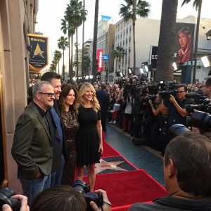 Celebrity family - Ed O'Neill, Christina Applegate, David Faustino, and Katey Sagal gathered at Hollywood event. Katey Sagal's star unveiled. Crowded red carpet with palm trees and natural light