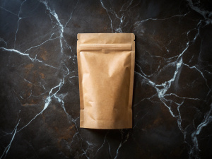 "Generate a kraft paper pouch bag viewed from the top, laying flat on a luxurious black marble surface. Add natural creases and light reflections for a more realistic effect."