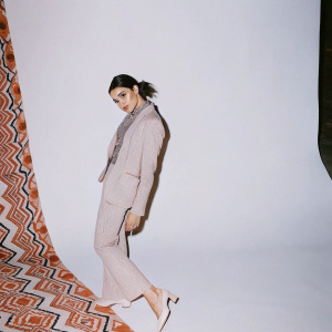 Deepika Padukone, in Van Heusen attire, poses for a high-fashion magazine spread. Stylized backdrop featuring trendy patterns and bold colors.