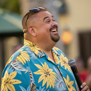 Gabriel Iglesias, stand-up comedian, photographed in a candid moment. Wearing a Hawaiian shirt, grinning widely