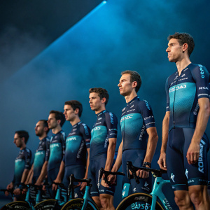 Cyclists of Astana team lined up for Giro della Toscana 2019. Dark blue backdrop. Serious expressions.
