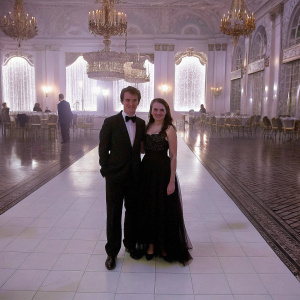 Dermot Mulroney and Tharita Catulle attend the annual Carousel of Hope Ball gala. Both are dressed in formal attire. Lavish ballroom setting with chandeliers.