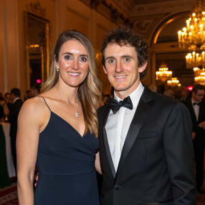 Geraint Thomas and Sara Elen, dressed in elegant attire, at a gala event. They are smiling and posing for a photo.