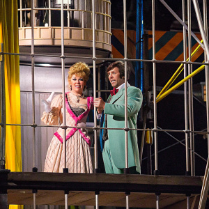 Debbie Reynolds and Harve Presnell on the set of 'The Unsinkable Molly Brown'. 1960s era costumes, wooden backdrop.