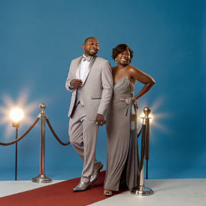 Omar Epps and Keisha Spivey walking on the glamorous Hollywood red carpet. He is wearing a tuxedo.