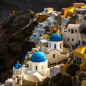 From above, the charming village of Oia, Santorini, Greece. White houses with blue accents, cliffside dwellings, stunning vistas.