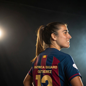 Patricia Guijarro Gutierrez, soccer star, poses confidently. Wearing team jersey, number 12. Dark background, spotlight effect
