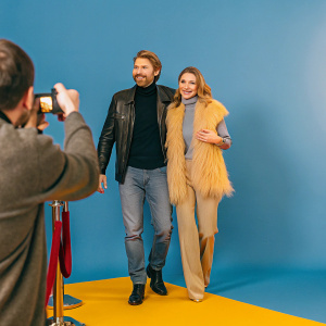 Chad Michael Murray and Sarah Roemer attending an award ceremony. Chad in a black turtleneck and leather jacket, Sarah in a grey outfit with a furry vest. Red carpet event.