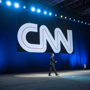 Large white CNN logo displayed on a dark blue backdrop.