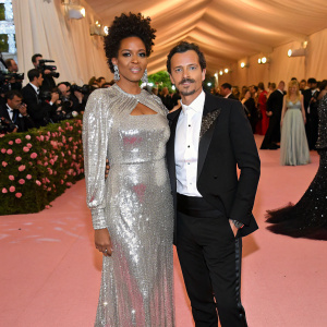 Kelis and Matthew Williamson at the Met Gala. She is in a stunning silver sequined gown. He is in a black tuxedo. The venue is filled with celebrities and paparazzi.