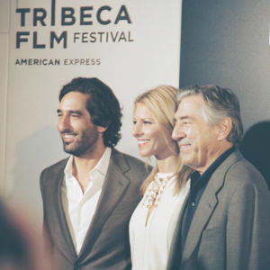 Ben Chaplin, Claire Danes, and Robert De Niro attending the premiere of their latest film at Tribeca Film Festival. They are standing together in front of a backdrop with bold Tribeca Film Festival and American Express logos. All three are dressed in formal attire and have warm, engaging smiles.