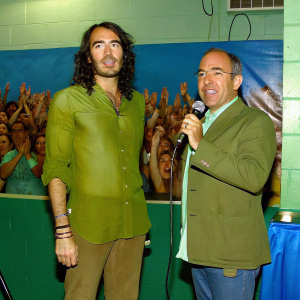 Russell Brand and Felipe Calderón attend a political rally. Crowd cheering in background.