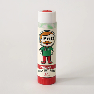 Pritt brand glue stick, cylindrical container, features cartoon character in green Pritt logo shirt. White packaging, red accents. 'Original', 'Solvent Free' text.
