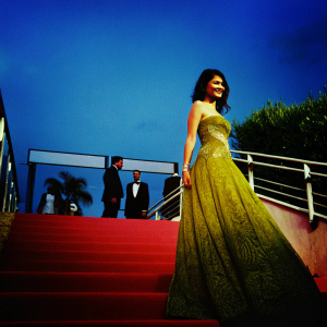 Alessandra Mastronardi at the Cannes Film Festival. Radiant smile, wearing a yellow strapless gown with intricate embroidery.