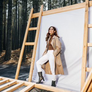 Janet Montgomery on the set of a fashion photoshoot. Dark forest green backdrop