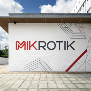 Modern logo for Mikrotik featuring stylized text and abstract geometric shapes on white backdrop